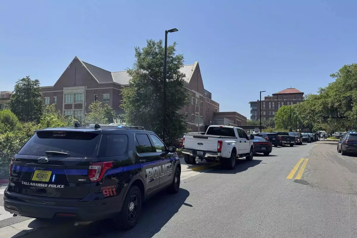 Dozens of patrol vehicles, including a forensics van, are stationed outside of Florida State University’s student union building, the scene of a shooting, Thursday, April 17, 2025, in Tallahassee, Fla. (AP Photo/Kate Payne)