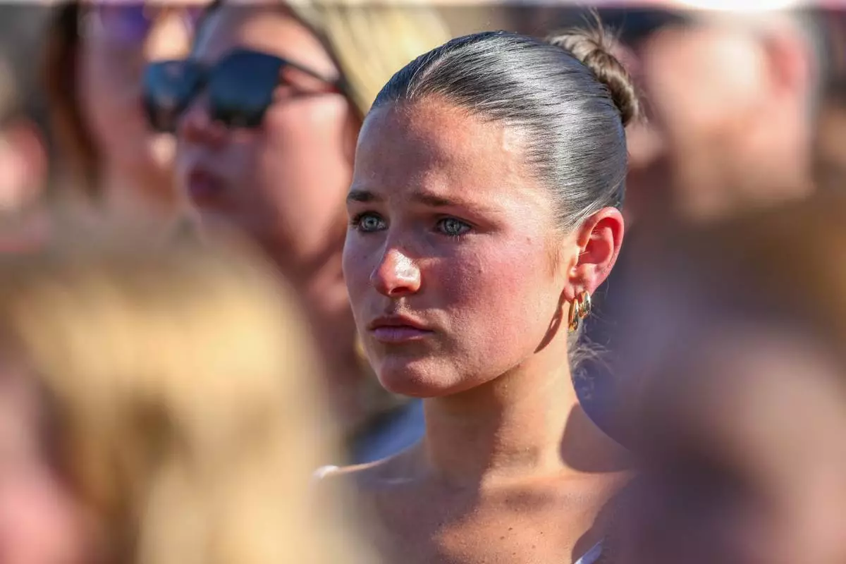 A student mourns during a vigil on the Florida State campus at Langford Green, Tallahassee, Fla., Friday, April 18, 2025. (AP Photo/Gary McCullough)