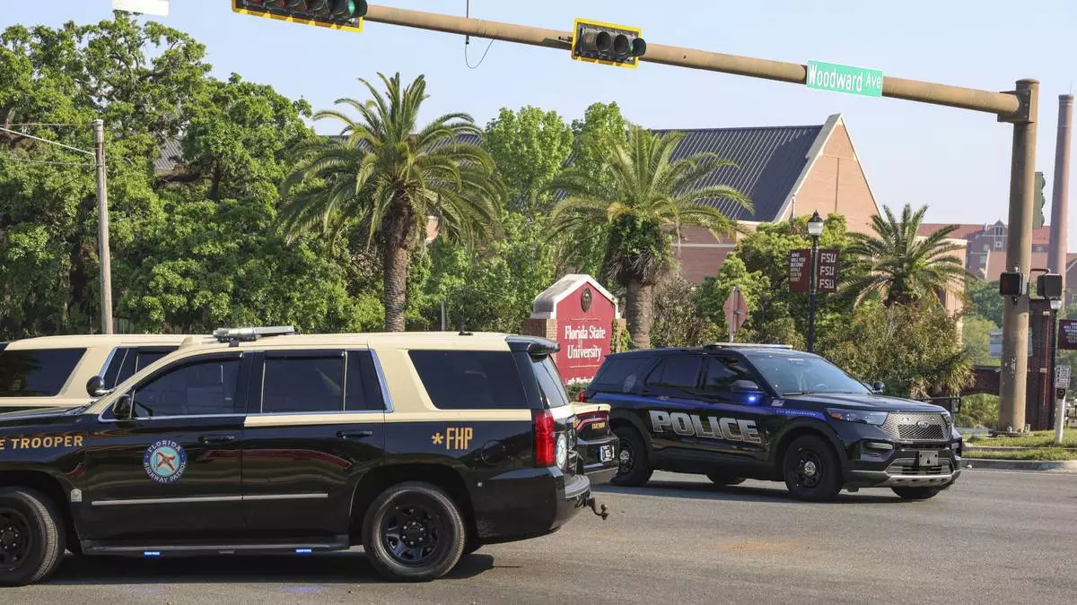 The Florida State Student Union building is seen behind law enforcement vehicles in Tallahassee, Fla., Thursday, April 17, 2025. (AP Photo/Gary McCullough)