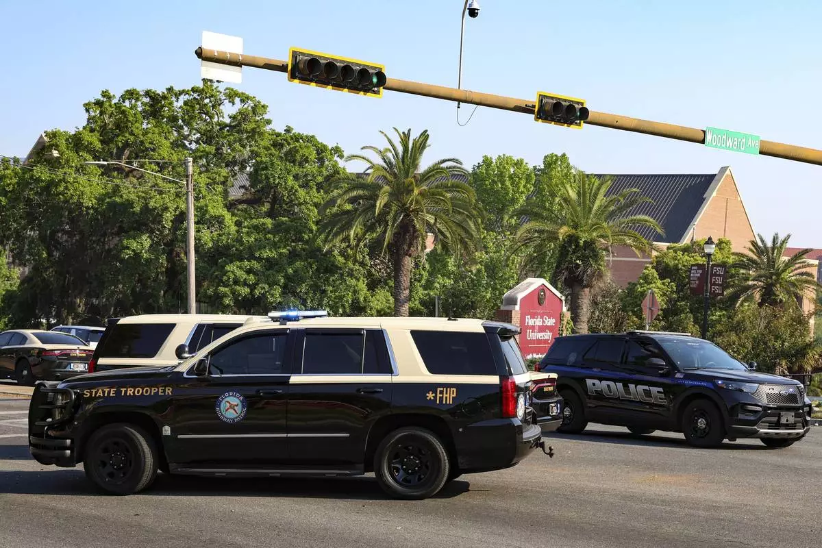 The Florida State Student Union building is seen behind law enforcement vehicles in Tallahassee, Fla., Thursday, April 17, 2025. (AP Photo/Gary McCullough)