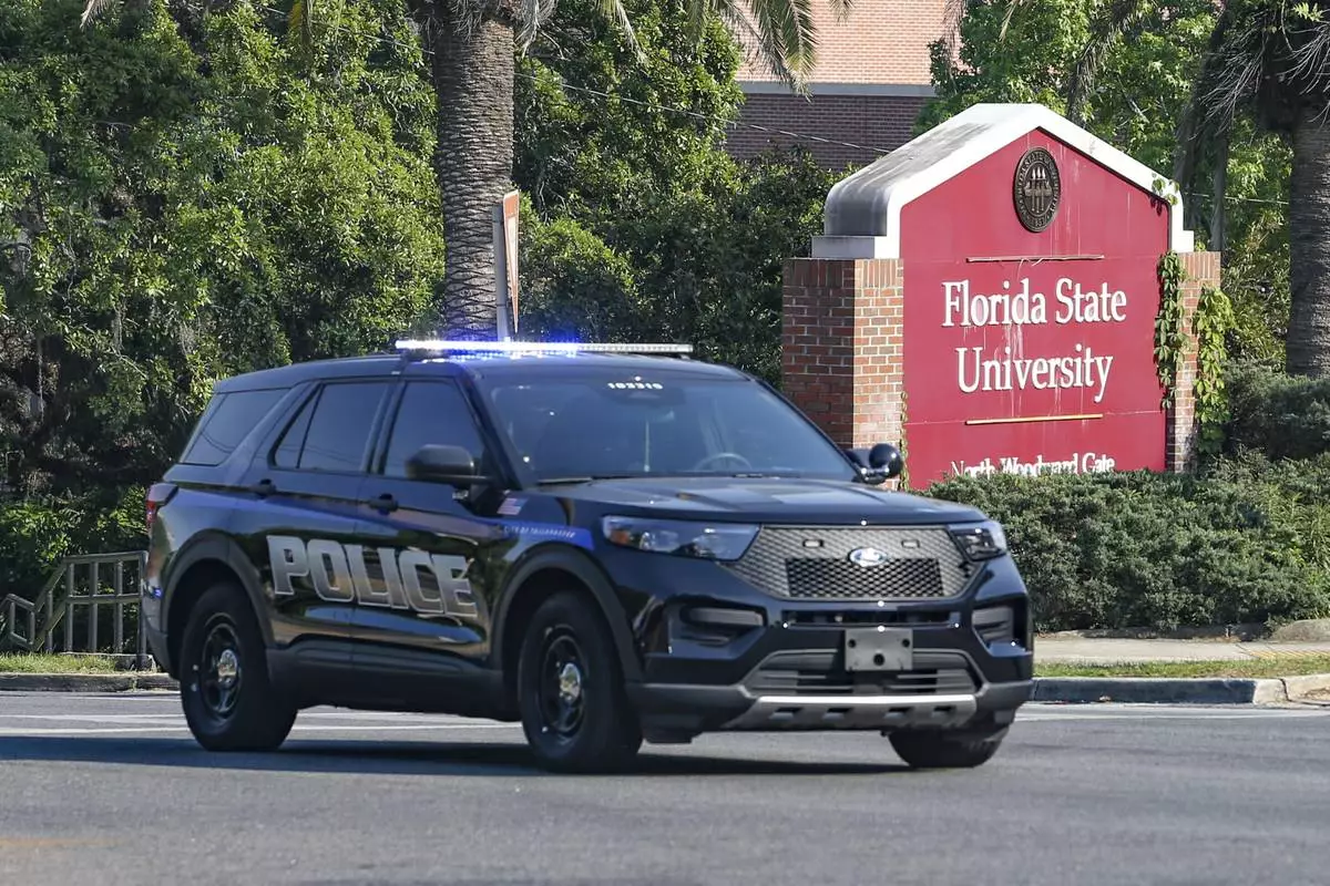 The Florida State Student Union building is seen behind law enforcement vehicles in Tallahassee, Fla., Thursday, April 17, 2025. (AP Photo/Gary McCullough)