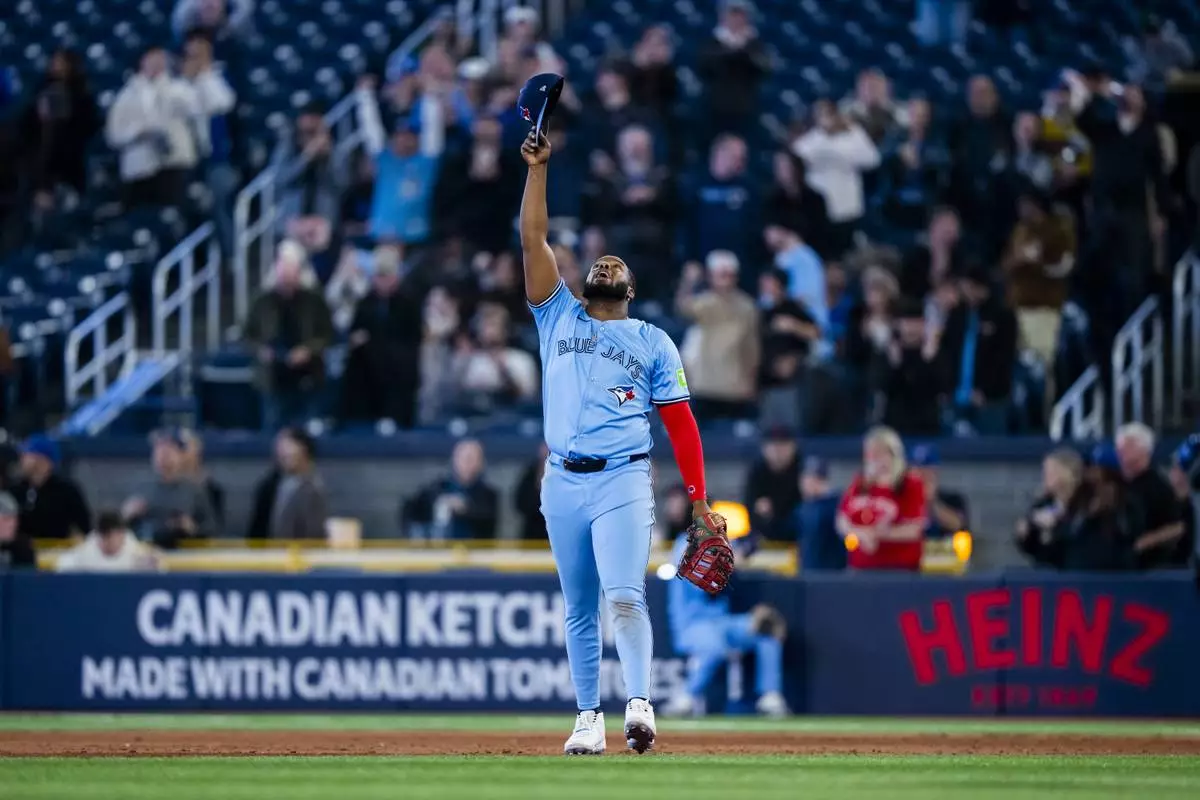 Toronto Blue Jays first base Vladimir Guerrero Jr. (27) celebrates a win over the Washington Nationals following MLB baseball action in Toronto, Monday, March 31, 2025. (Thomas Skrlj/The Canadian Press via AP)