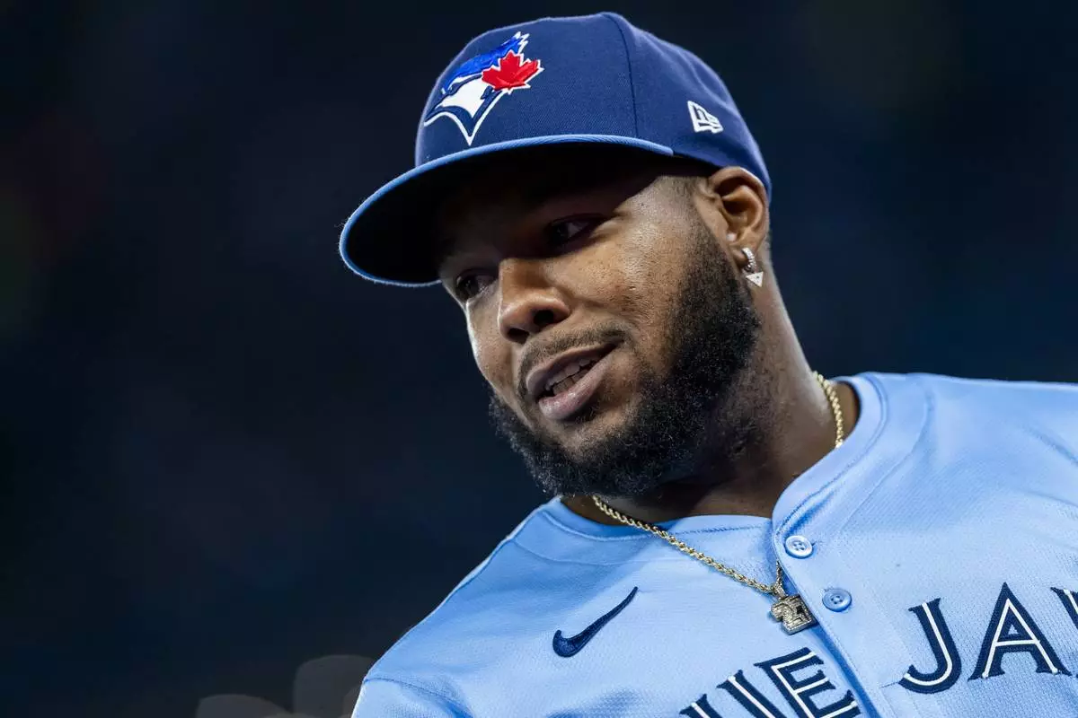 Toronto Blue Jays first base Vladimir Guerrero Jr. (27) looks on prior to MLB baseball action against the Washington Nationals, in Toronto, Monday, March 31, 2025. (Thomas Skrlj/The Canadian Press via AP)
