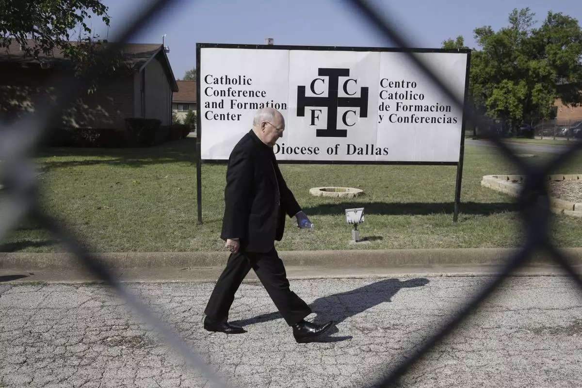FILE - Catholic Bishop Kevin Farrell walks to speak to media outside the the Diocese of Dallas Catholic Conference and Formation Center on Oct. 20, 2014. (AP Photo/LM Otero, File)