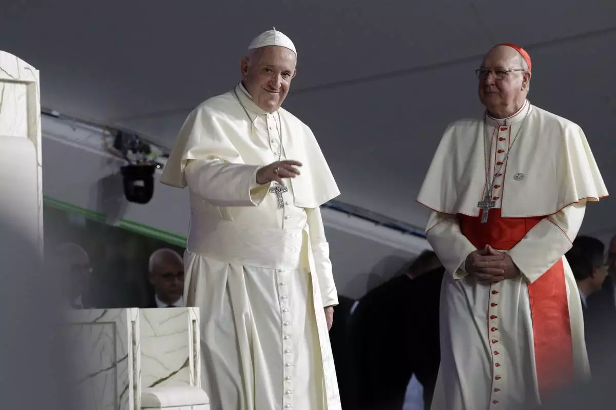 FILE - Pope Francis, left, is flanked by Cardinal Kevin Farrell during a vigil at Campo San Juan Pablo II in Panama City, Jan. 26, 2019. (AP Photo/Alessandra Tarantino, File )