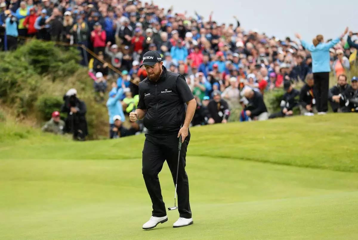 FILE - Ireland's Shane Lowry reacts after getting a birdie on the fourth green during the final round of the British Open Golf Championships at Royal Portrush in Northern Ireland, Sunday, July 21, 2019. (AP Photo/Peter Morrison, File)