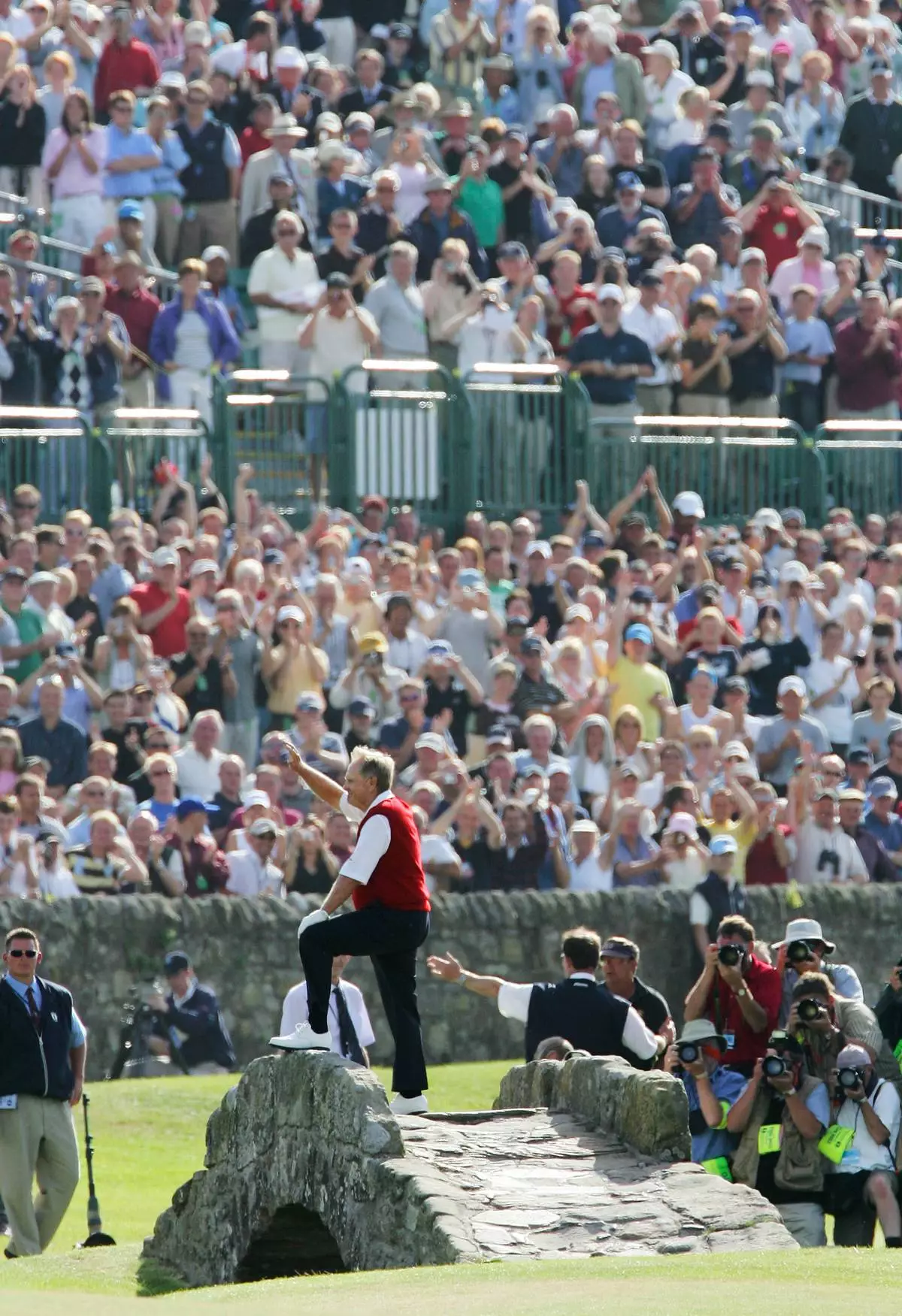 FILE - Golf legend Jack Nicklaus waves to spectators from the Swilcan Bridge on the 18th hole as he comes close to the end of playing his final round ever in the British Open golf championship on the Old Course at St. Andrews, Scotland, Friday July 15, 2005.. (AP Photo/Laurent Rebours, File)