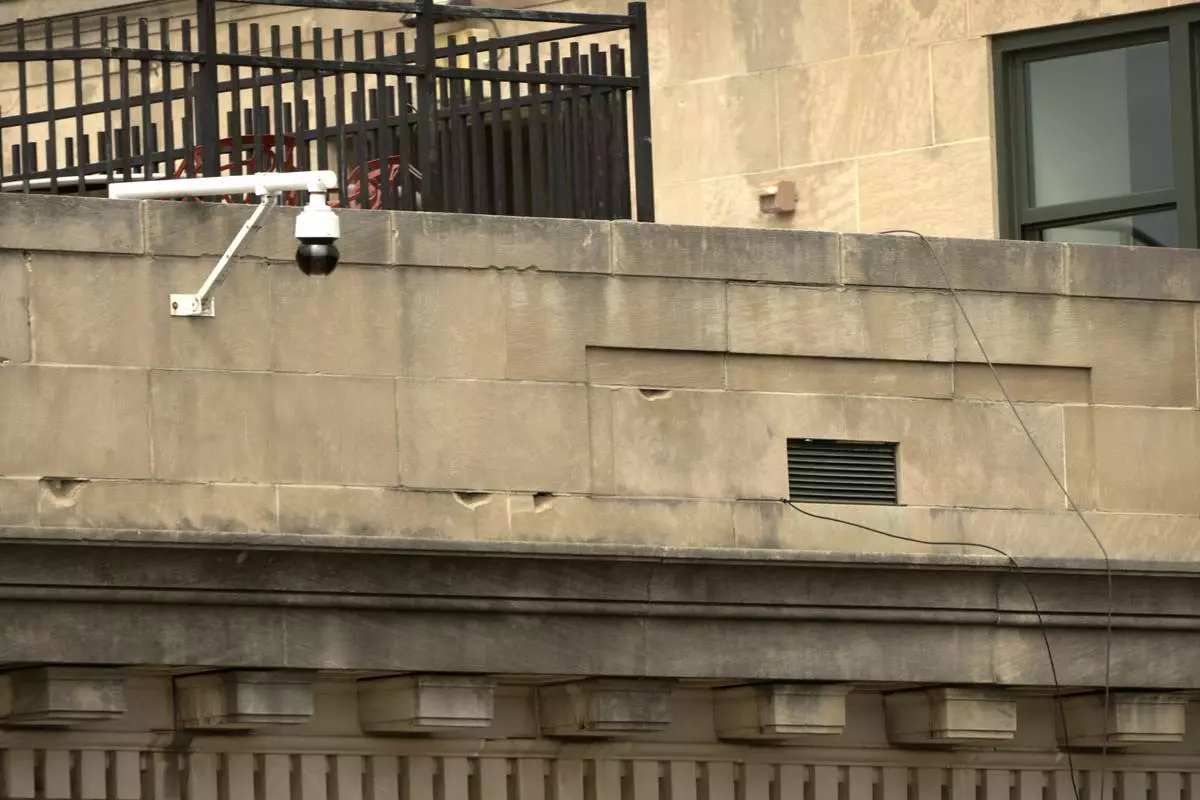 Wires are seen leading from a top floor corner window to the roof of the headquarters of the General Services Administration (GSA) are seen on Wednesday, April 2, 2025, in Washington. (AP Photo/Mark Schiefelbein)
