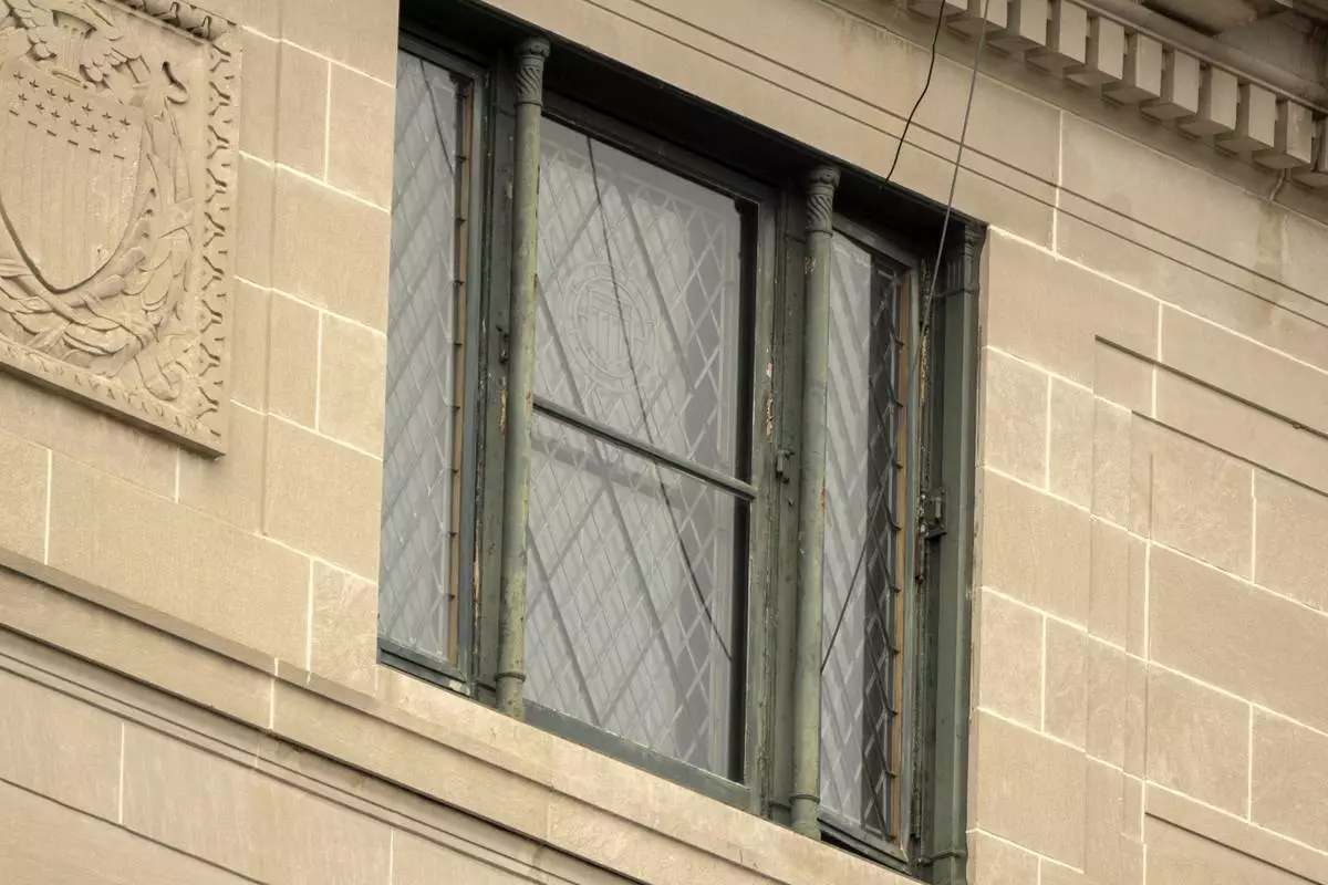 Wires are seen leading from a top floor corner window to the roof of the headquarters of the General Services Administration (GSA) Wednesday, April 2, 2025, in Washington. (AP Photo/Mark Schiefelbein)