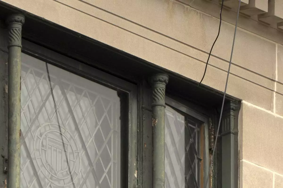Wires are seen leading from a top floor corner window to the roof of the headquarters of the General Services Administration (GSA) are photographed Wednesday, April 2, 2025, in Washington. (AP Photo/Mark Schiefelbein)