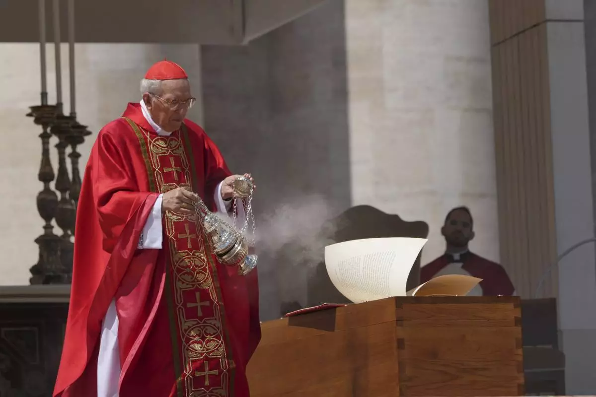Dean of the College of Cardinals Giovanni Battista Re blesses the coffin during the funeral of Pope Francis in St. Peter's Square at the Vatican, Saturday, April 26, 2025. (AP Photo/Alessandra Tarantino)