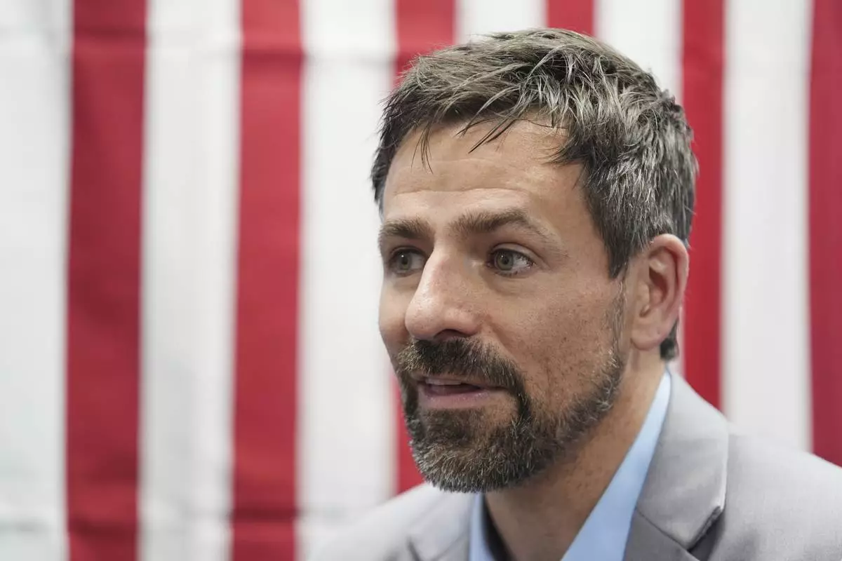 Ryan Kelley talks with attendees after speaking at the Jackson County Republican Party headquarters, Thursday, April 10, 2025, in Jackson, Mich. (AP Photo/Paul Sancya)