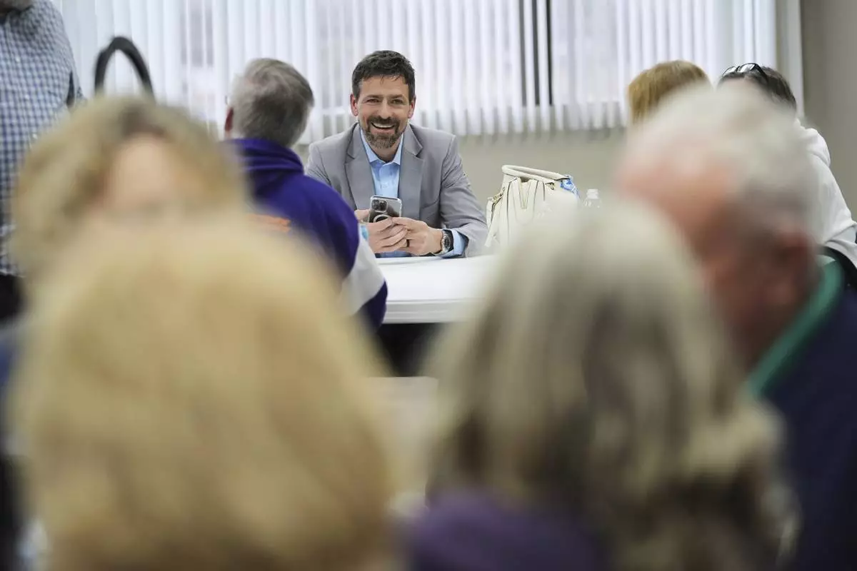 Ryan Kelley talks with attendees before speaking at the Jackson County Republican headquarters, Thursday, April 10, 2025, in Jackson, Mich. (AP Photo/Paul Sancya)