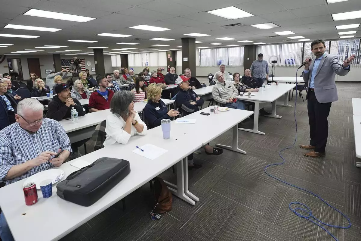 Ryan Kelley, right, speaks at the Jackson County Republican headquarters, Thursday, April 10, 2025, in Jackson, Mich. (AP Photo/Paul Sancya)