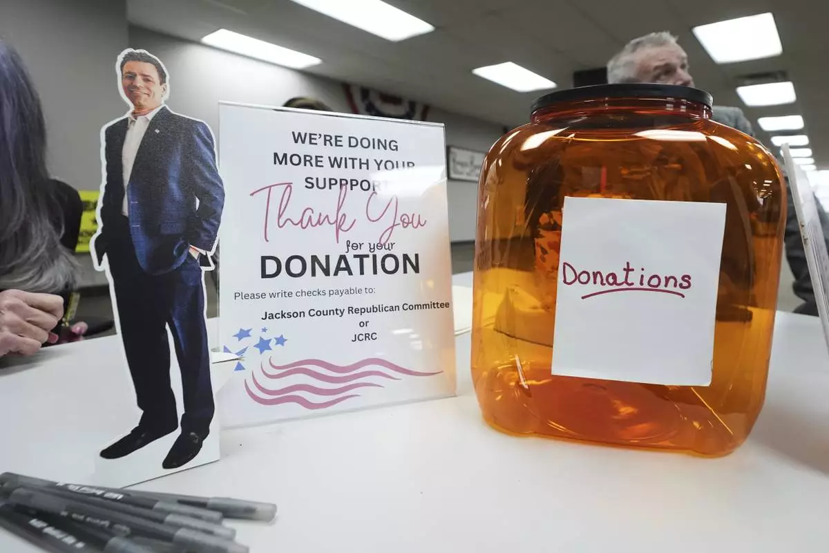 A small cutout of Ryan Kelley sits on the registration table before his talk at the Jackson County Republican headquarters, Thursday, April 10, 2025, in Jackson, Mich. (AP Photo/Paul Sancya)