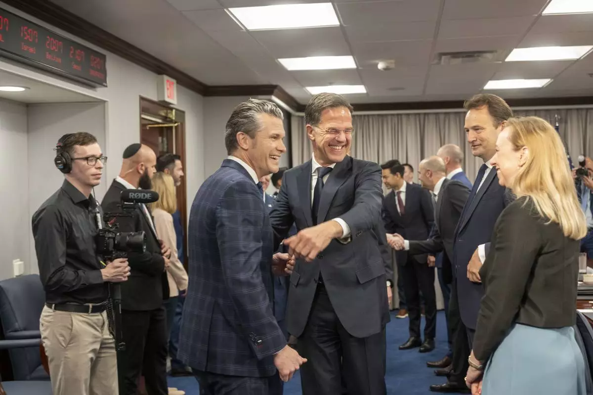Defense Secretary Pete Hegseth, center left, shares a laugh with NATO Secretary General Mark Rutte, center right, before the start of a meeting, Thursday, April 24, 2025 in Washington. (AP Photo/Kevin Wolf)