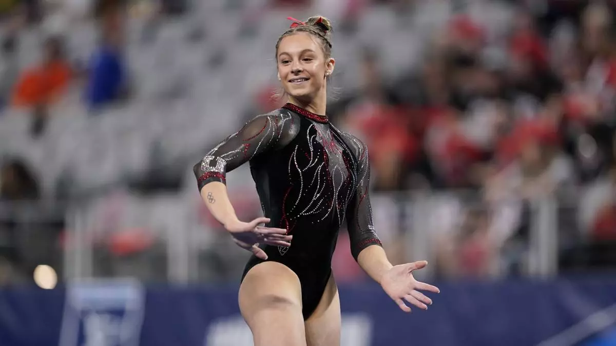 FILE - Utah's Grace McCallum completes on the floor exercise during the NCAA women's gymnastics championships, April 14, 2022, in Fort Worth, Texas. (AP Photo/Tony Gutierrez, file)