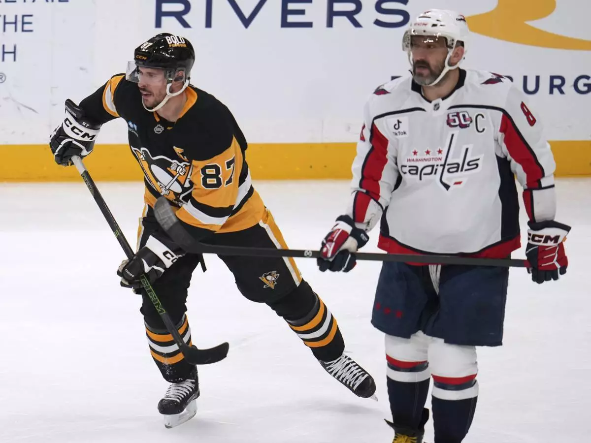 Pittsburgh Penguins' Sidney Crosby (87) and Washington Capitals' Alex Ovechkin (8) skate during the first period of an NHL hockey game in Pittsburgh, Thursday, April 17, 2025. (AP Photo/Gene J. Puskar)