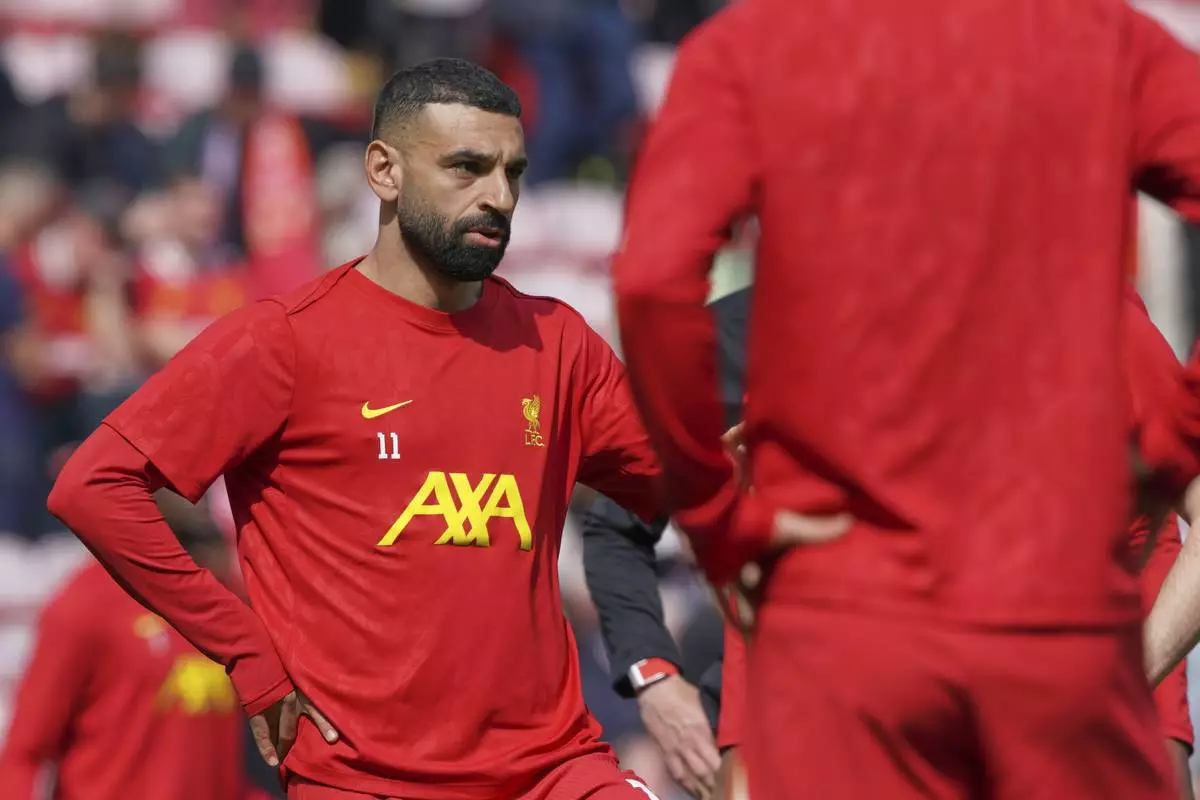 Liverpool's Mohamed Salah warms up prior to the English Premier League soccer match between Liverpool and West Ham United at Anfield in Liverpool, Sunday, April 13, 2025. (AP Photo/Ian Hodgson)