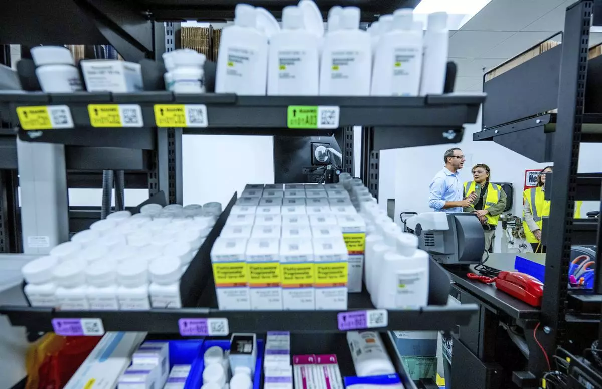 FILE - Media and local officials tour a new Amazon pharmacy, adjacent to a fulfillment center, in Corona, Calif. on Wednesday, May 29, 2024. (Terry Pierson/The Orange County Register via AP, File)