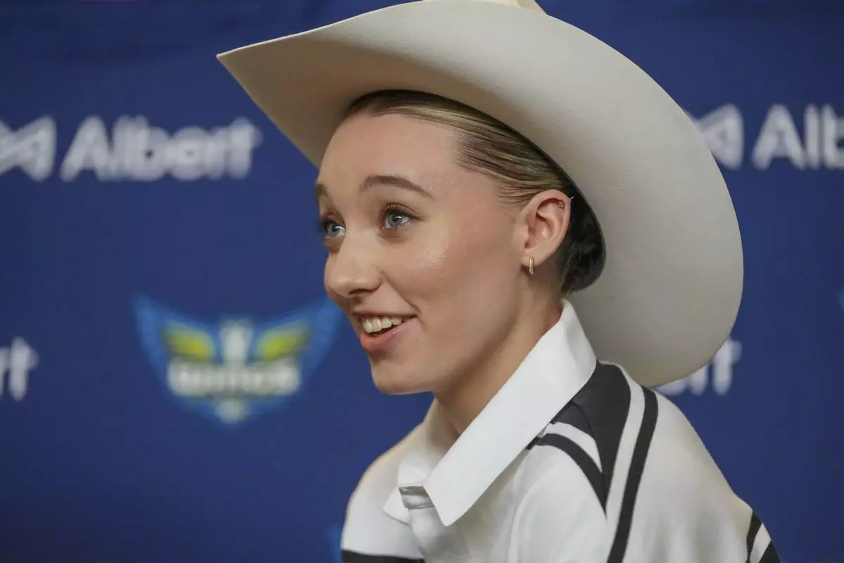 Dallas Wings' Paige Bueckers, selected No. 1 overall in the WNBA basketball draft, sports a cowboy hat gifted to her during an introductory press conference Wednesday, April 23, 2025, in Dallas. (AP Photo/Julio Cortez)