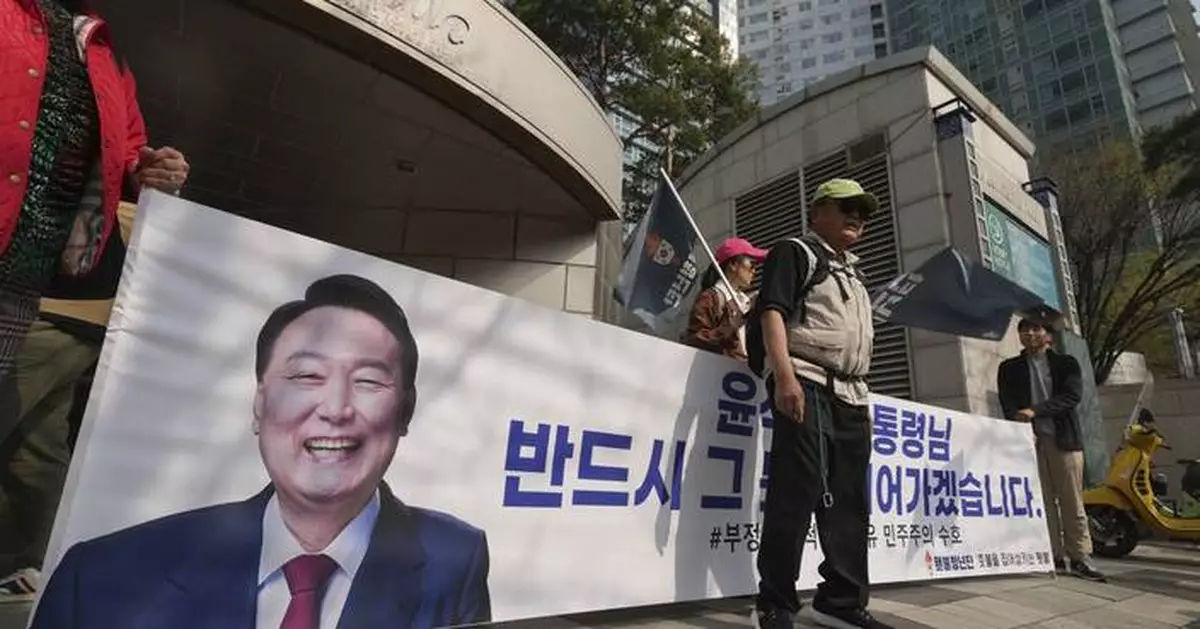 Ousted South Korean President Yoon embraces supporters after leaving presidential residence
