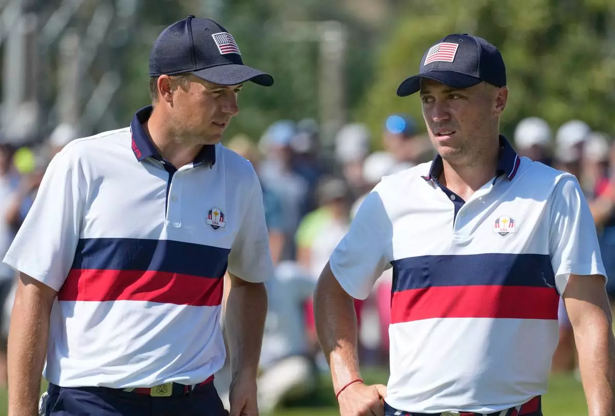 FILE - United States' Jordan Spieth, speaks to his playing partner United States' Justin Thomas on the 10th green at the Ryder Cup golf tournament at the Marco Simone Golf Club in Guidonia Montecelio, Italy, Sept. 30, 2023. (AP Photo/Andrew Medichini, file)