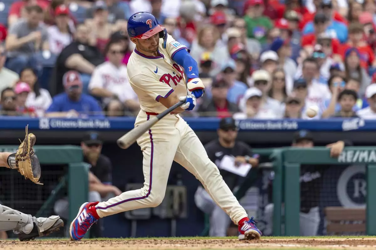 Philadelphia Phillies' Trea Turner hits an RBI single during the third inning of a baseball game against the Miami Marlins, Saturday, April 19, 2025, in Philadelphia. (AP Photo/Laurence Kesterson)