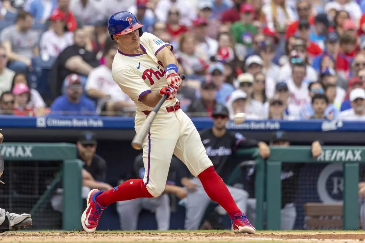 Philadelphia Phillies' J.T. Realmuto hits a double in the second inning of a baseball game against the Miami Marlins, Saturday, April 19, 2025, in Philadelphia. (AP Photo/Laurence Kesterson)