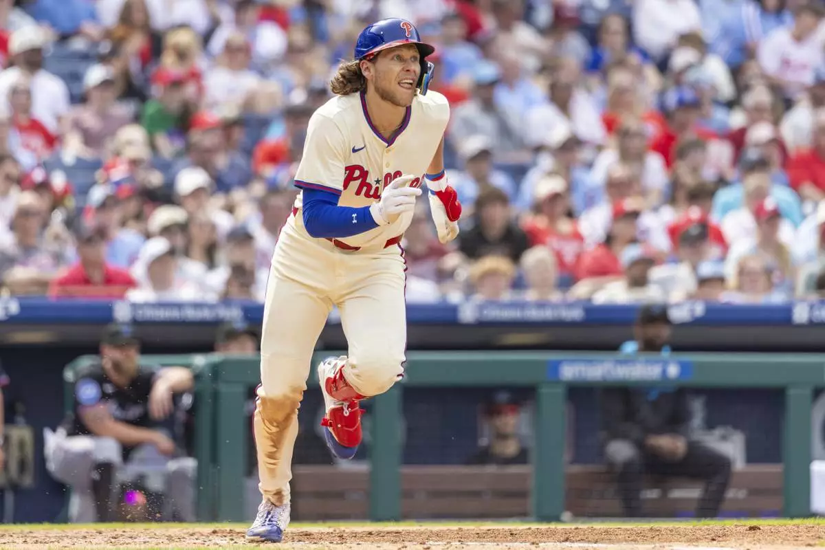 Philadelphia Phillies' Alec Bohm runs to first after hitting a double in the fifth inning of a baseball game against the Miami Marlins, Saturday, April 19, 2025, in Philadelphia. (AP Photo/Laurence Kesterson)