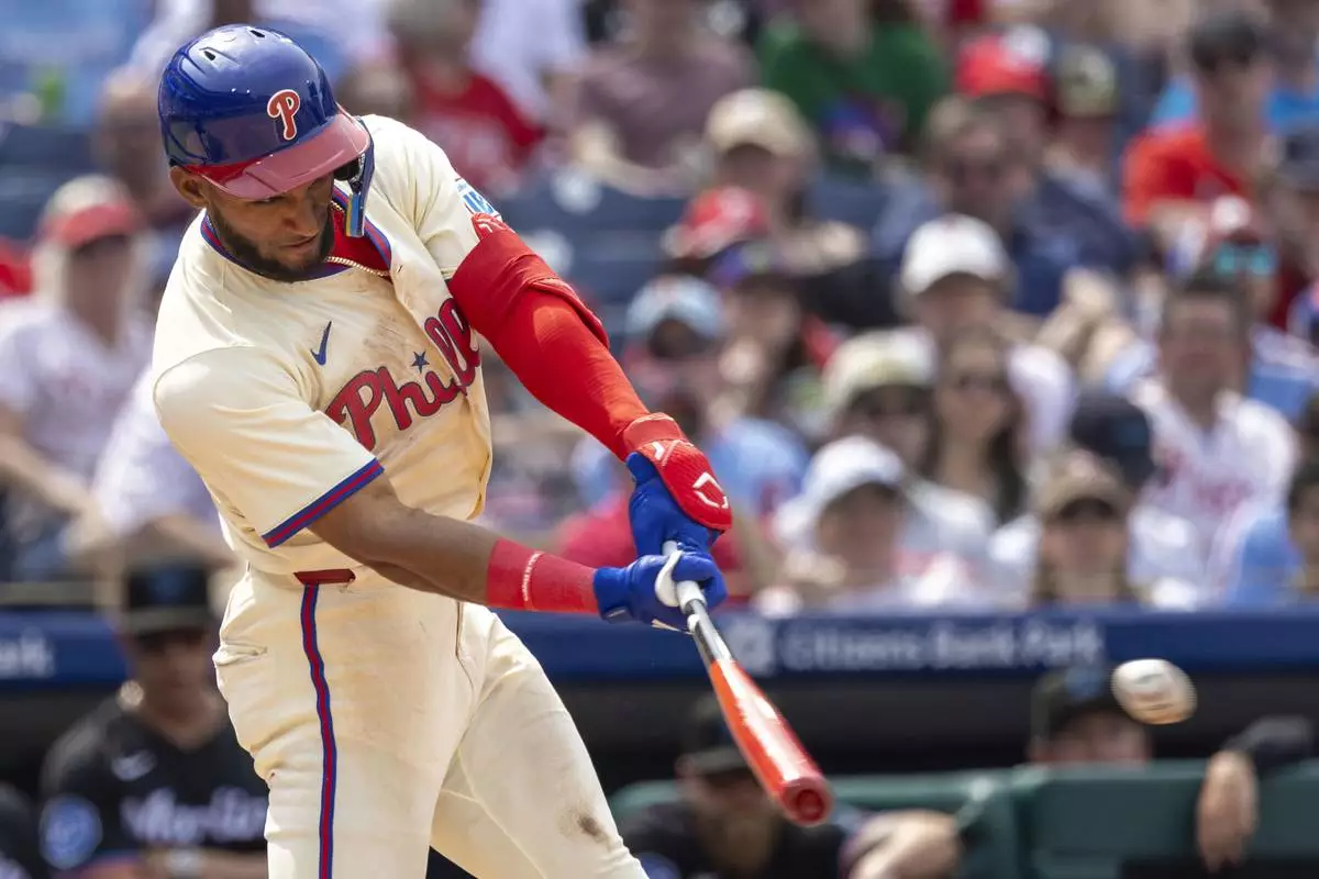 Philadelphia Phillies' Johan Rojas hits an RBI single in the fifth inning of a baseball game against the Miami Marlins, Saturday, April 19, 2025, in Philadelphia. (AP Photo/Laurence Kesterson)