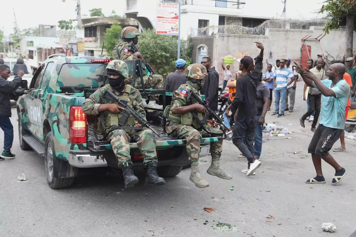 Haitian army soldiers patrol during a protest against insecurity in Port-au-Prince, Haiti, Wednesday, April 16, 2025. (AP Photo/Odelyn Joseph)
