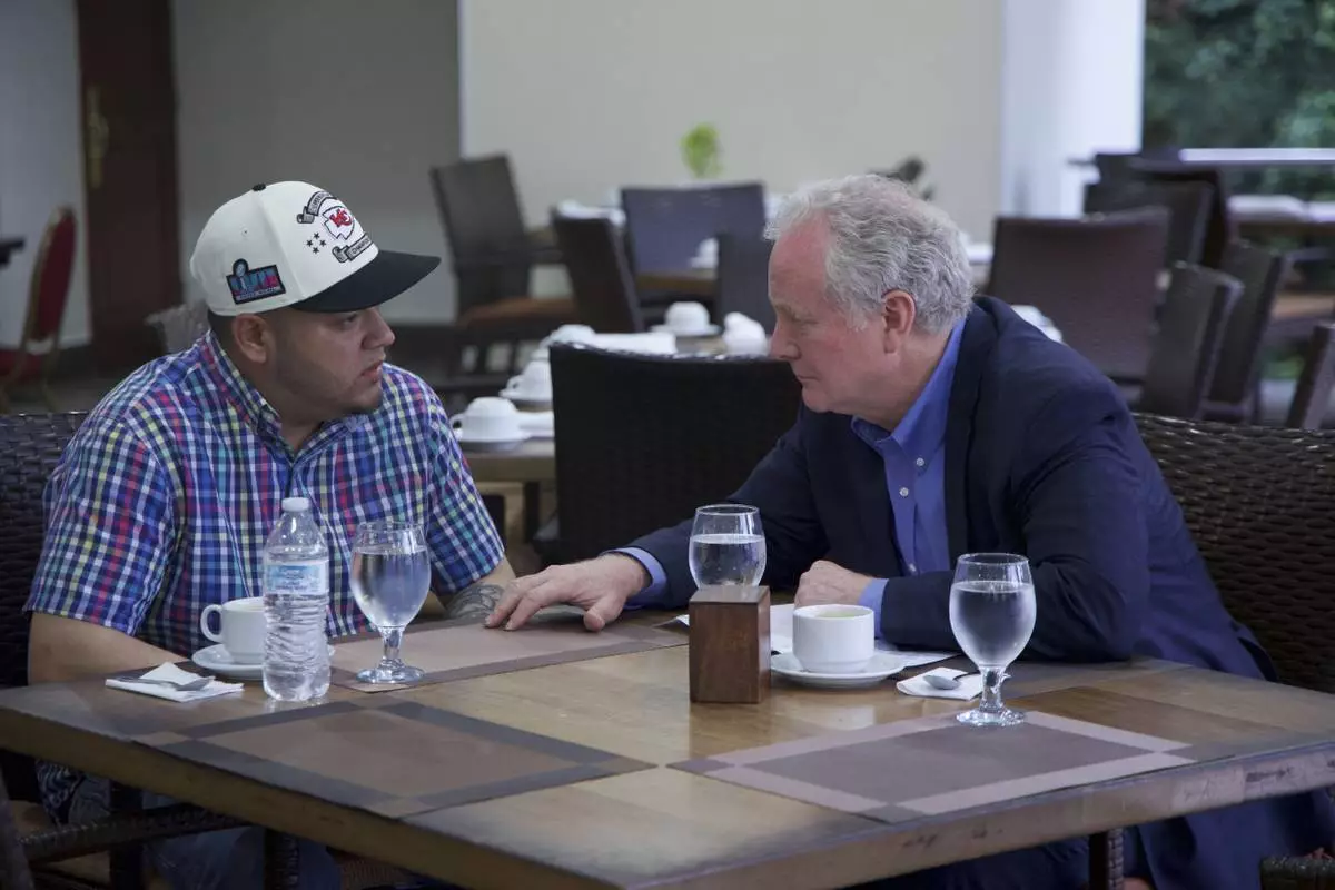 In this photo released by Senator Van Hollen's press office, Hollen, right, speaks with Kilmar Abrego Garcia, a Salvadoran citizen who was living in Maryland and deported to El Salvador by the Trump administration, in a hotel restaurant in San Salvador, El Salvador, Thursday, April 17, 2025. (Press Office Senator Van Hollen, via AP)