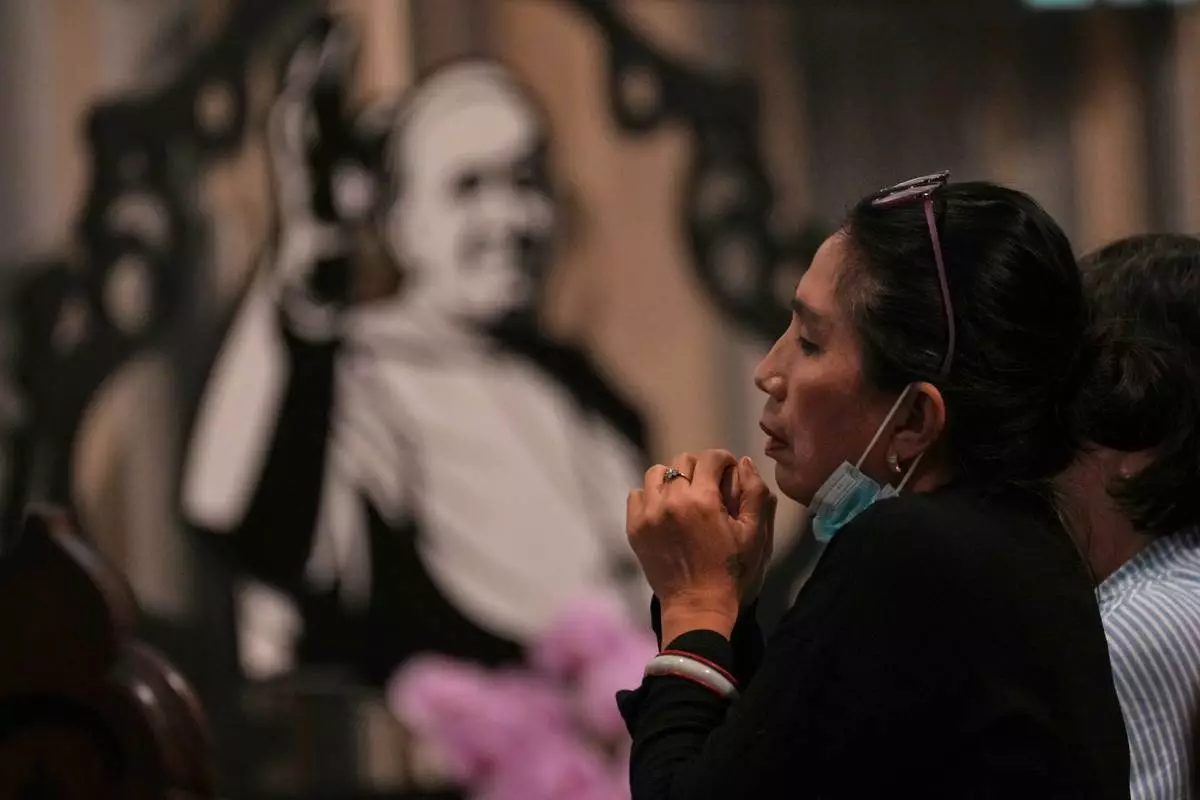 A woman prays during a mass at the Church of Our Lady of the Assumption which visited Pope Francis visited in 2024, in Jakarta, Indonesia, Monday, April 21, 2025. (AP Photo/Achmad Ibrahim)