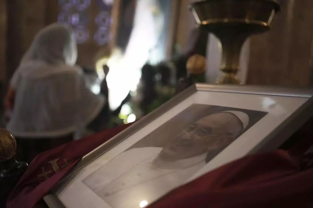 A photo of the late Pope Francis is placed at the Basilica of the Agony or Gethsemane after the news of his death at age 88, in Jerusalem, on Monday, April 21, 2025. (AP Photo/Maya Alleruzzo)