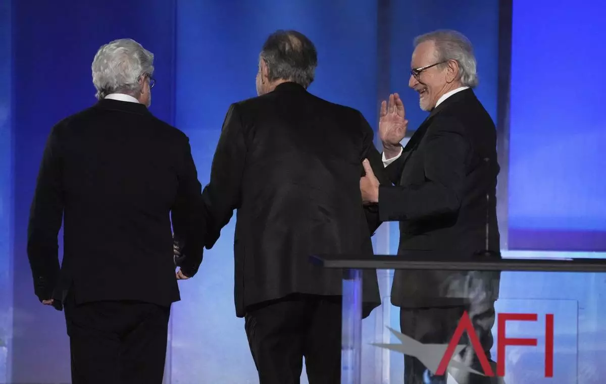 Filmmakers George Lucas, left, Francis Ford Coppola, center, and Steven Spielberg leave the stage together at the close of the 50th AFI Life Achievement Award tribute to Coppola on Saturday, April 26, 2025, at the Dolby Theatre in Los Angeles. (AP Photo/Chris Pizzello)