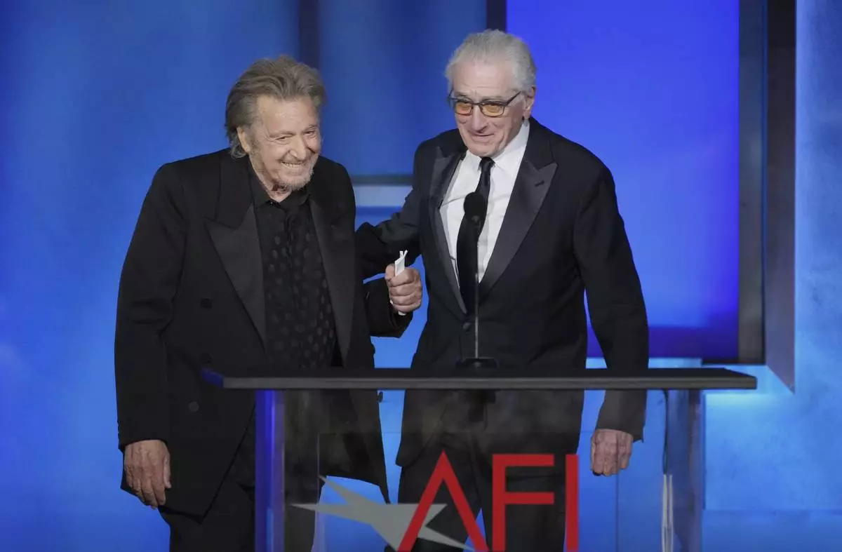 Actors Al Pacino, left, and Robert De Niro arrive onstage during the 50th AFI Life Achievement Award tribute to Francis Ford Coppola on Saturday, April 26, 2025, at the Dolby Theatre in Los Angeles. (AP Photo/Chris Pizzello)