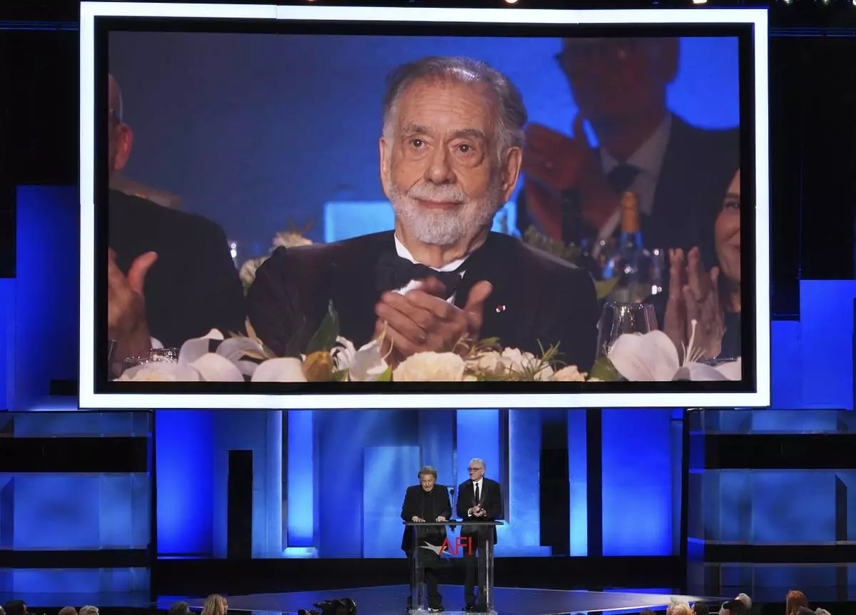 Filmmaker Francis Ford Coppola is seen on a video monitor as actors Al Pacino, left, and Robert De Niro talk about his career during the 50th AFI Life Achievement Award tribute to Coppola on Saturday, April 26, 2025, at the Dolby Theatre in Los Angeles. (AP Photo/Chris Pizzello)