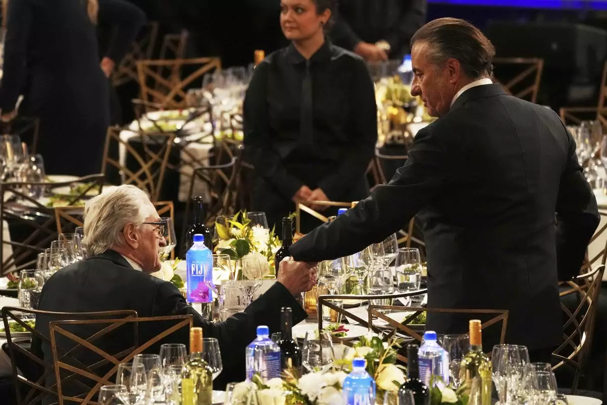 Actors Robert De Niro, left, and Andy Garcia mingle before the 50th AFI Life Achievement Award tribute to Francis Ford Coppola on Saturday, April 26, 2025, at the Dolby Theatre in Los Angeles. (AP Photo/Chris Pizzello)