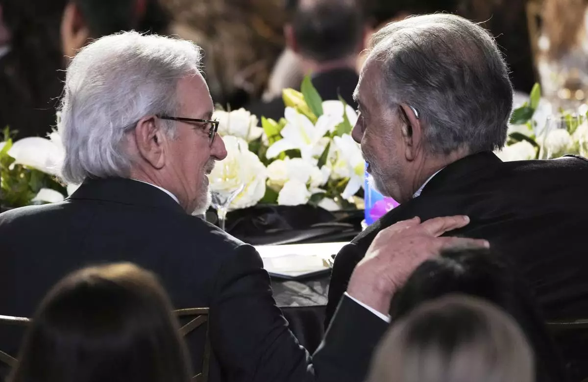 Filmmakers Steven Spielberg, left, and Francis Ford Coppola mingle during the 50th AFI Life Achievement Award tribute to Coppola on Saturday, April 26, 2025, at the Dolby Theatre in Los Angeles. (AP Photo/Chris Pizzello)