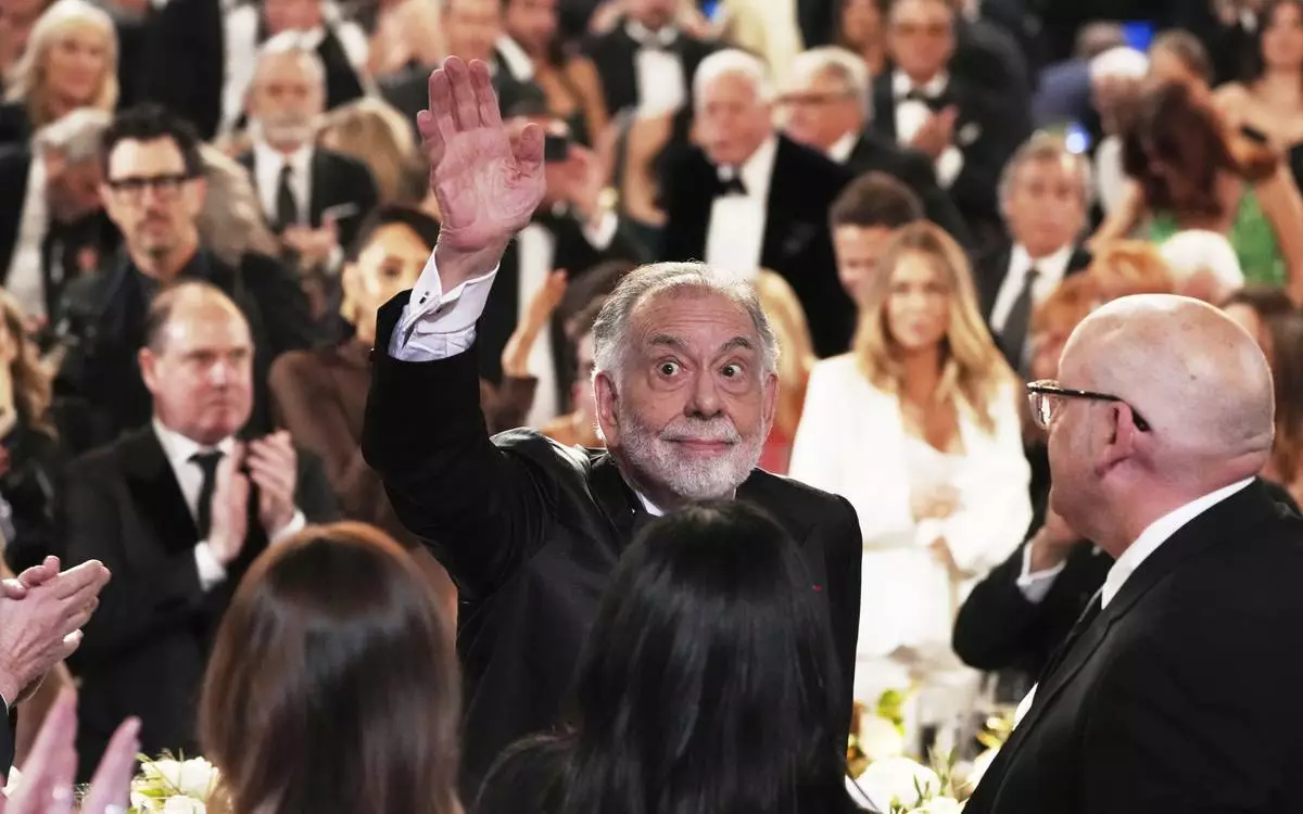 Filmmaker Francis Ford Coppola waves to the audience upon arriving at the 50th AFI Life Achievement Award tribute to him on Saturday, April 26, 2025, at the Dolby Theatre in Los Angeles. (AP Photo/Chris Pizzello)