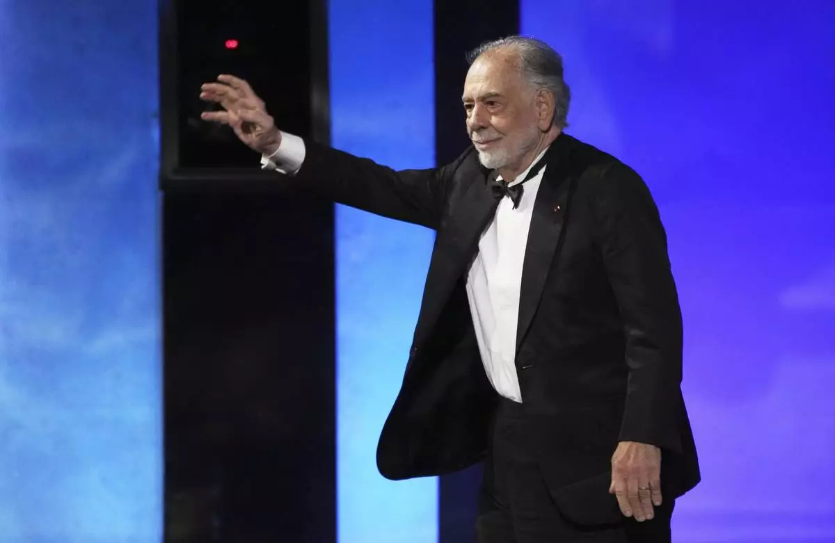 Filmmaker Francis Ford Coppola waves to the audience as he takes the stage during the 50th AFI Life Achievement Award tribute to Coppola on Saturday, April 26, 2025, at the Dolby Theatre in Los Angeles. (AP Photo/Chris Pizzello)