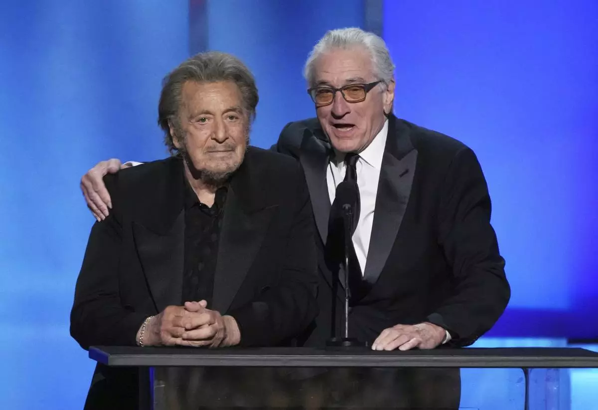 Actors Al Pacino, left, and Robert De Niro address the audience during the 50th AFI Life Achievement Award tribute to Francis Ford Coppola on Saturday, April 26, 2025, at the Dolby Theatre in Los Angeles. (AP Photo/Chris Pizzello)