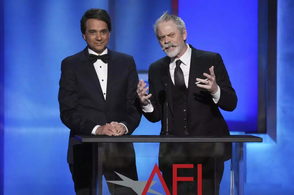 Actors Ralph Macchio, left, and C. Thomas Howell address the audience during the 50th AFI Life Achievement Award tribute to Francis Ford Coppola on Saturday, April 26, 2025, at the Dolby Theatre in Los Angeles. (AP Photo/Chris Pizzello)
