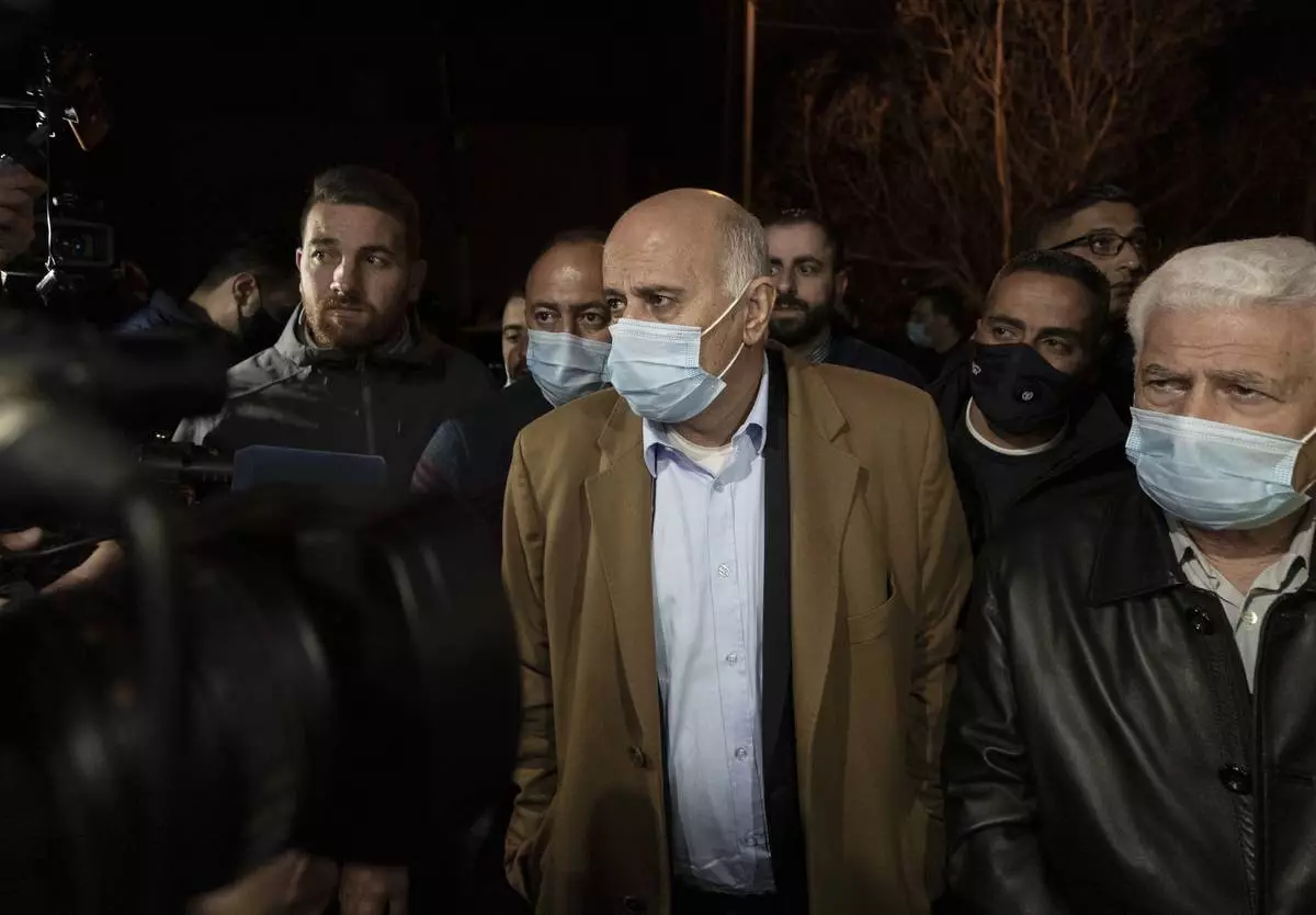 FILE - Senior Fatah official Jibril Rajoub, center, arrives at the Palestinian Central Election Commission office in the West Bank city of Ramallah on March 31, 2021, to register for a parliamentary election. (AP Photo/Nasser Nasser, File)