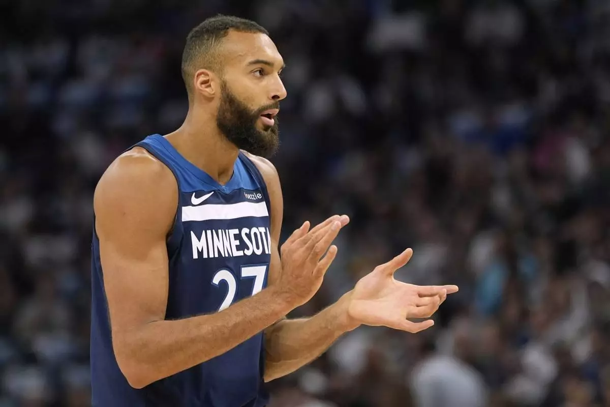 Minnesota Timberwolves center Rudy Gobert (27) claps during the first half of an NBA basketball game against the Utah Jazz, Sunday, April 13, 2025, in Minneapolis. (AP Photo/Abbie Parr)