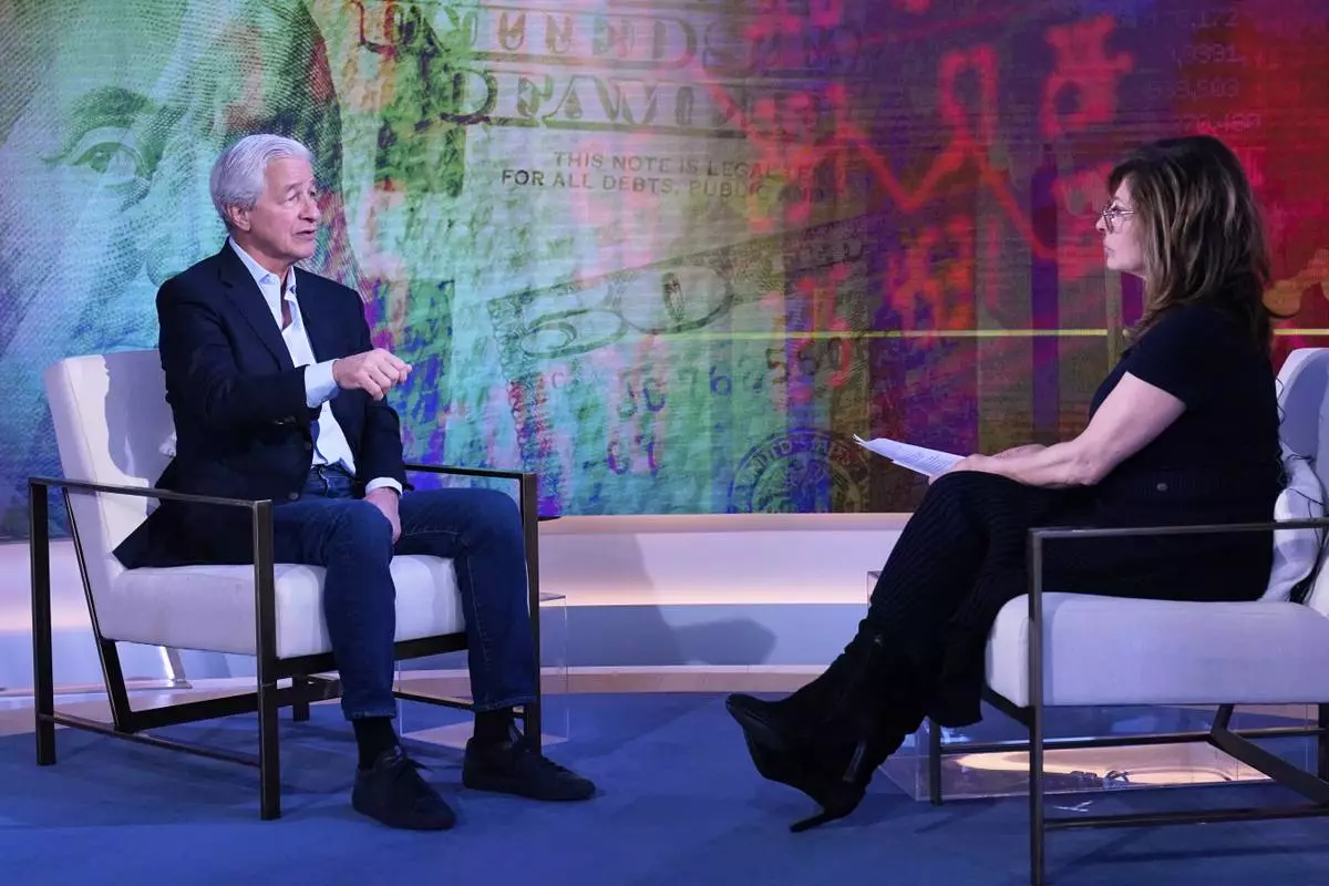 JPMorgan CEO Jamie Dimon, left, is interviewed by Maria Bartiromo on the "Mornings with Maria Bartiromo" program, on the Fox Business Network, in New York Wednesday, April 9, 2025. (AP Photo/Richard Drew)