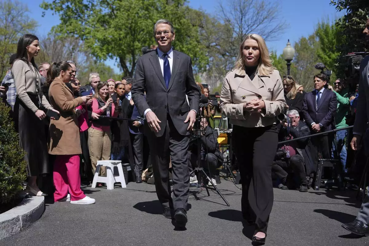 Treasury Secretary Scott Bessent and White House press secretary Karoline Leavitt depart after speaking to reporters outside the West Wing of the White House, Wednesday, April 9, 2025, in Washington. (AP Photo/Evan Vucci)