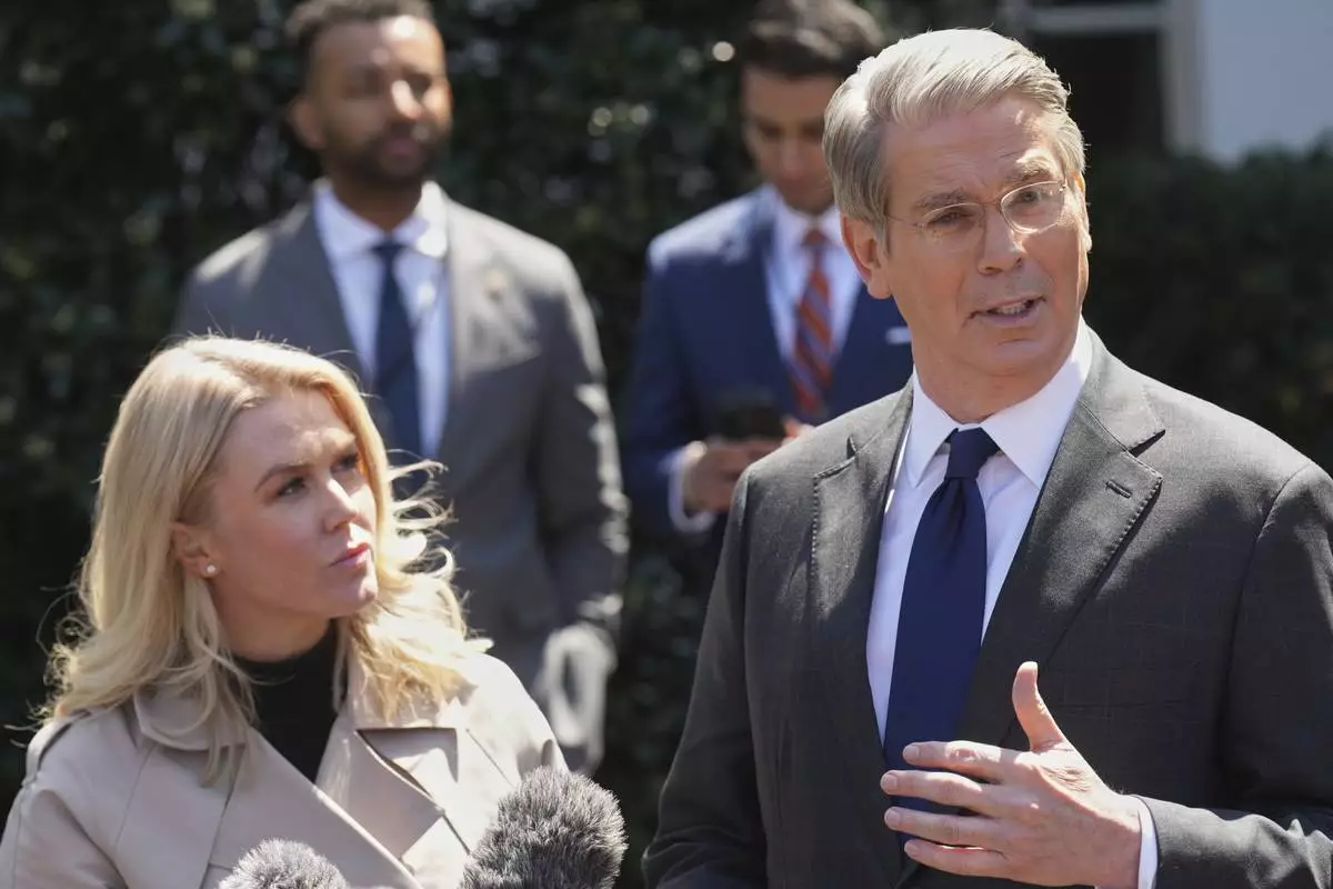 Treasury Secretary Scott Bessent speaks to reporters outside the West Wing of the White House, Wednesday, April 9, 2025, in Washington, with White House press secretary Karoline Leavitt. (AP Photo/Jacquelyn Martin)
