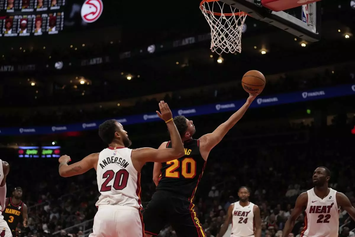 Atlanta Hawks forward Georges Niang (20) shoots against Miami Heat forward Kyle Anderson (20) in the first half of an NBA play-in tournament basketball game, Friday, April 18, 2025, in Atlanta. (AP Photo/Brynn Anderson)